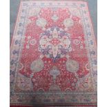 A Kirman carpet, the claret field with overall flowering shrub and palmette design centred by an