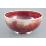 A Ruskin high fired flambe footed bowl, dated 1924, the exterior with sang de boeuf and mushroom