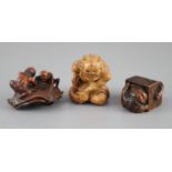 Three Japanese boxwood or cherry netsuke of oni, Meiji period, the first depicting a seated oni