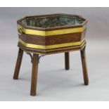 A George III brass bound mahogany wine cooler, of elongated octagonal form with metal liner, on a