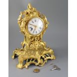 A 19th century French ormolu mantel clock, with ornate pierced foliate scroll case and enamelled