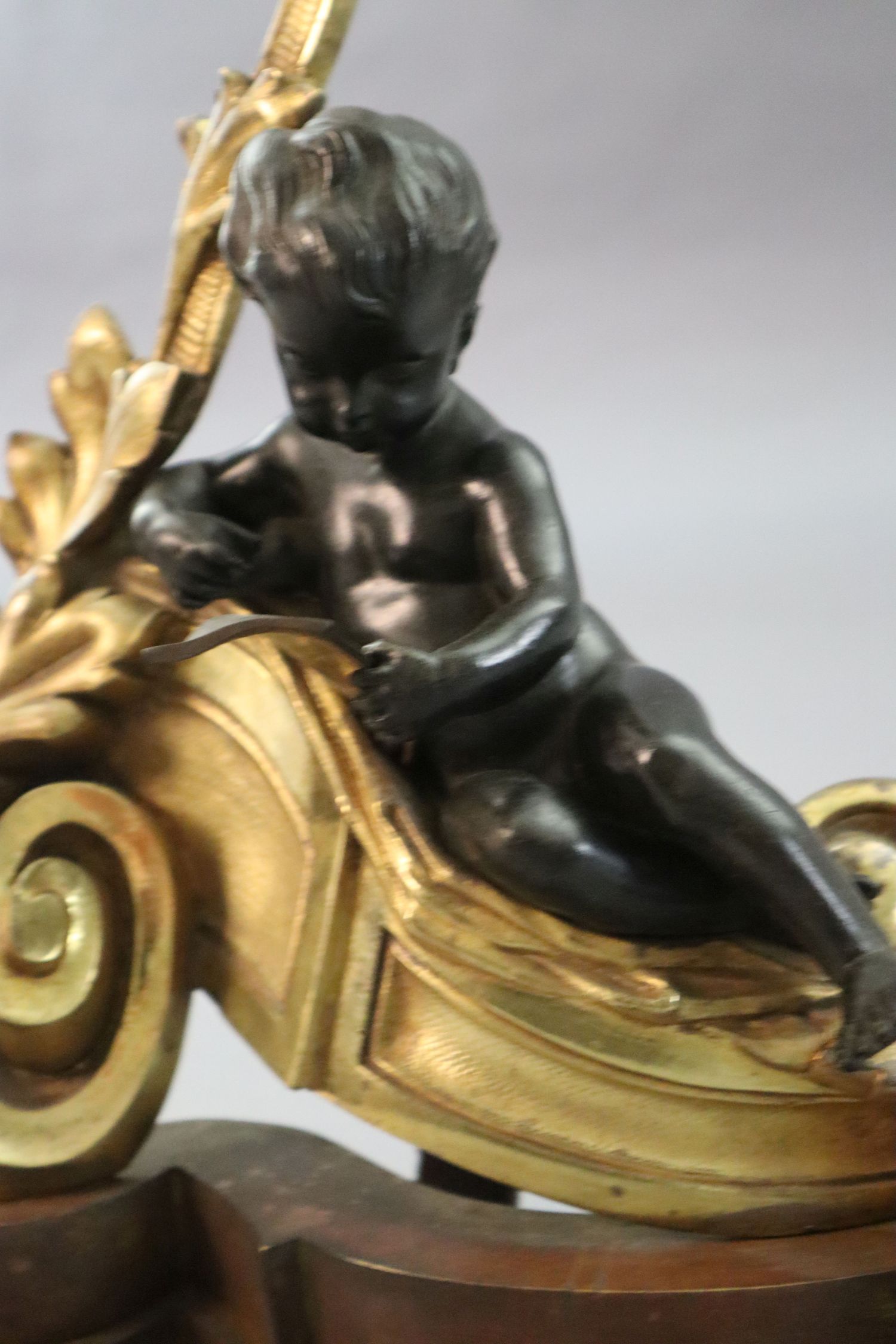 A Louis XVI style bronze and ormolu fender, with putto and foliate scroll terminals, length 48in. - Image 4 of 5