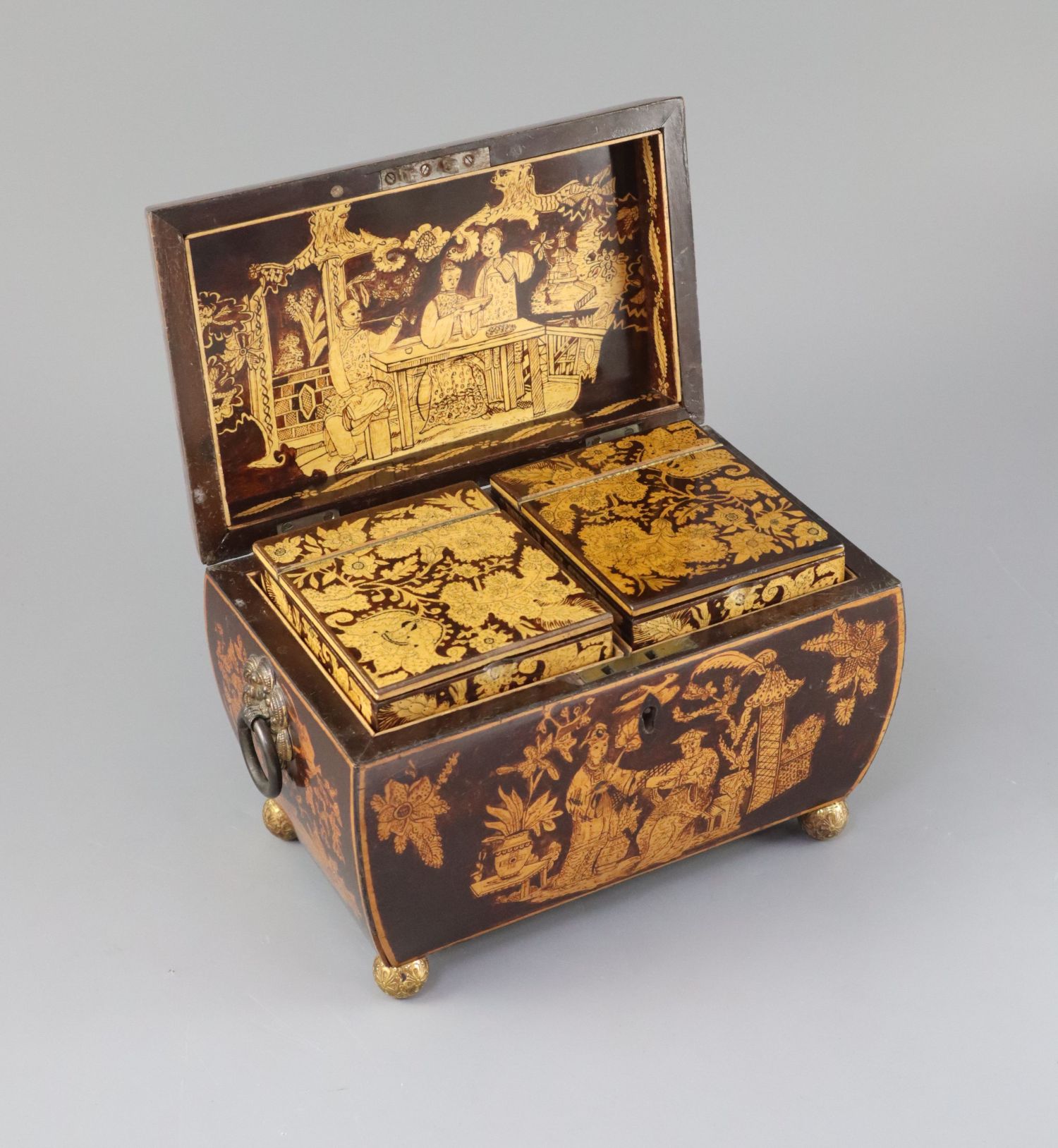 A Regency penwork tea caddy, of sarcophagus form, decorated with chinoiserie figures in gardens, the