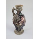 A Roman amethyst glass ewer, 1st/2nd century AD, mould blown in the form of a head with applied