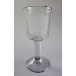 A George II plain stem armorial wine glass, c.1750, the bucket shaped bowl wheel engraved with the