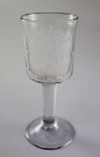 A George II plain stem armorial wine glass, c.1750, the bucket shaped bowl wheel engraved with the