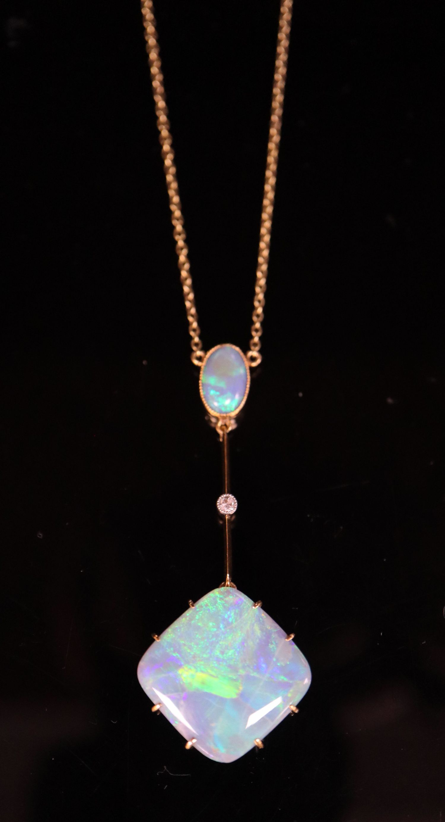 An early 20th century 15ct gold, diamond and two stone opal set drop pendant necklace, pendant 50mm,