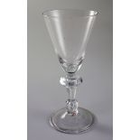 An English or Dutch light baluster wine glass, c.1740, the funnel shaped bowl above a teardrop