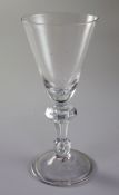 An English or Dutch light baluster wine glass, c.1740, the funnel shaped bowl above a teardrop