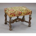 A late 17th century walnut dressing stool, with scroll carved legs, arched stretcher and fluted