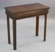 A George III mahogany card table, with ovolo carved rim and blind fret carved frieze incorporating a