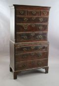 A mid 18th century featherbanded walnut chest on chest, fitted three short and six graduated long