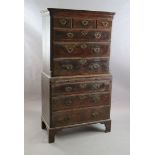 A mid 18th century featherbanded walnut chest on chest, fitted three short and six graduated long