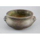 A large Chinese bronze gui censer, the baluster shaped body cast in relief with a pair of lion-