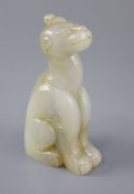 A Chinese pale celadon and russet jade figure of a mythical beast, the figure seated with a single