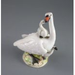 A Meissen group of a swan with cygnets, late 19th century, on a naturalistic mound base, crossed