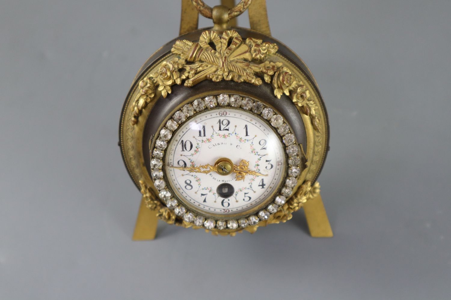 An early 20th century French bronze and ormolu desk timepiece, of cartel clock form resting upon - Image 2 of 4