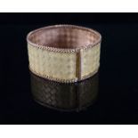 An 18k two colour gold broad mesh link bracelet, 19.2cm, 65.6 grams.CONDITION: Very slight kink to