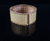 An 18k two colour gold broad mesh link bracelet, 19.2cm, 65.6 grams.CONDITION: Very slight kink to