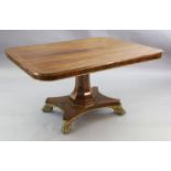 A Regency brass mounted rosewood breakfast table, with rounded rectangular tilt top, brass stringing