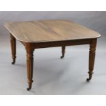 A Victorian mahogany extending dining table, with rounded rectangular top and three spare leaves, on