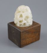 A Chinese white jade hat finial, carved in high relief and openwork with scrolling leaves and