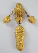 An 18th century ormolu chatelaine, cast with classical figures and scrolls, the main central body