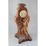 An unusual French Art Nouveau walnut mantel clock, carved in relief with a wood nymph dancing