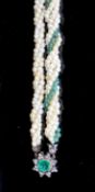 An early 20th century interwoven seed pearl and emerald bead set double strand bracelet, with foil