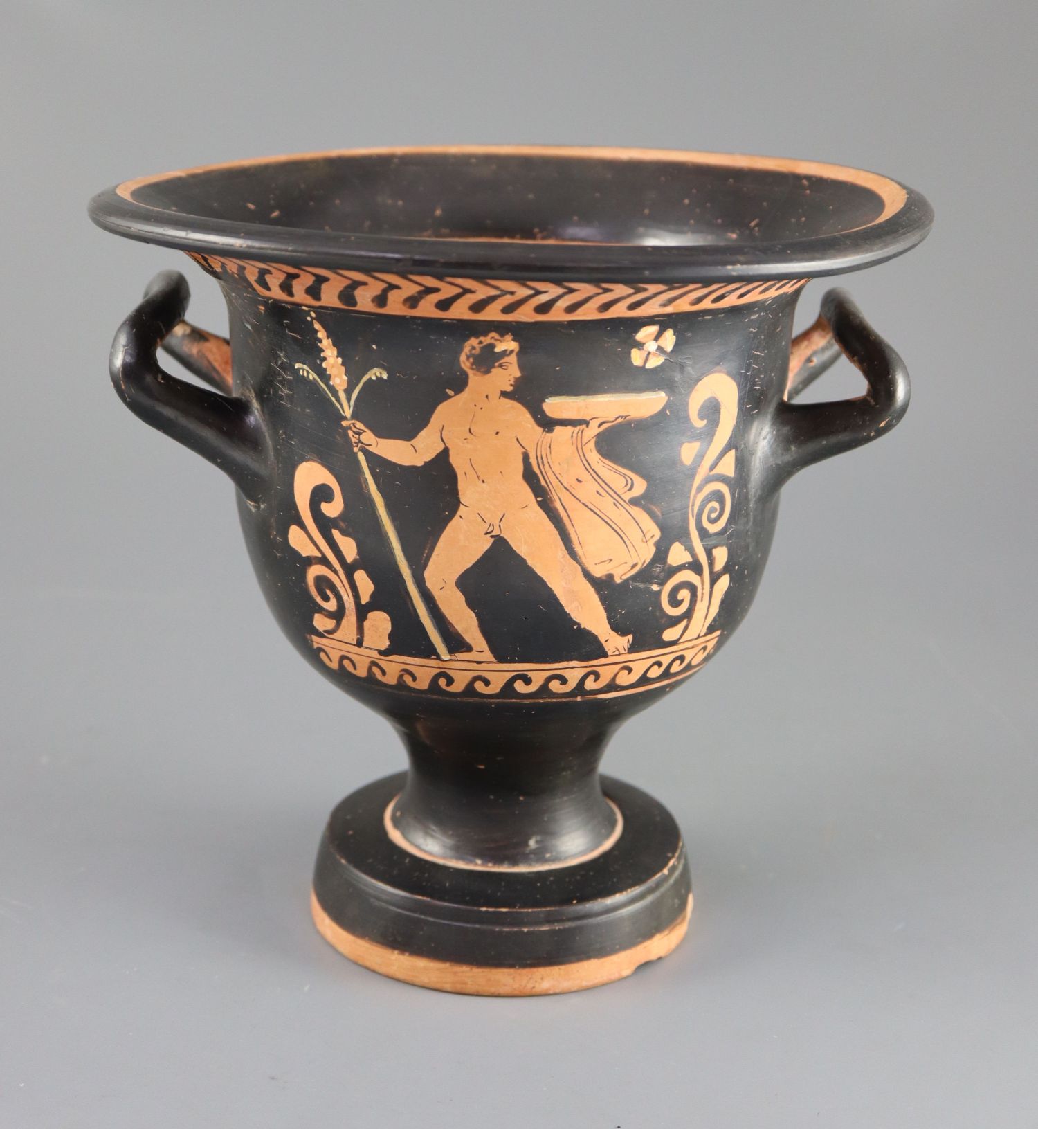 An Apulian red figure bell krater, Southern Italy c. 4th century BC, painted with a woman's head,