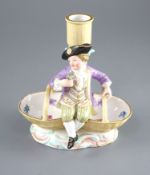 A Meissen figural candlestick, 19th century, in the form of a boy seated on a double basket, on