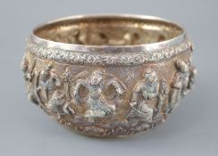 A 19th century Burmese silver bowl, embossed with Buddhist figures and elephants including winged,
