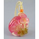 A Chinese rose quartz pendant carving of a peach and lingzhi fungus, the carver skillfully
