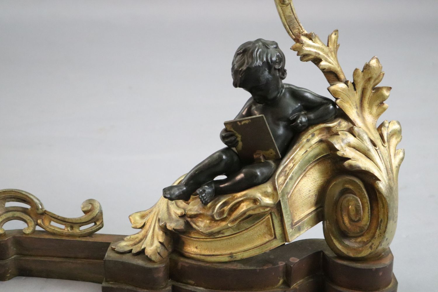 A Louis XVI style bronze and ormolu fender, with putto and foliate scroll terminals, length 48in. - Image 3 of 5