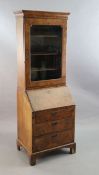 An early 18th century banded walnut bureau bookcase with moulded cornice and single glazed door,