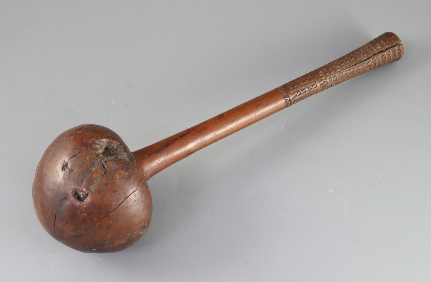 A 19th century Fijian Ula throwing club, with geometric carved handle, length 15.75in. diameter 4.