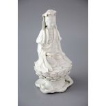 A Chinese Dehua blanc de chine seated figure of Guanyin, 18th/19th century, the figure holding a