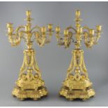 A pair of late 19th century French ormolu six light candelabra, with foliate scroll vineous