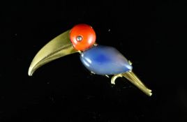 A mid 20th century French 18ct gold, coral and cabochon blue chalcedony? set Toucan clip brooch by