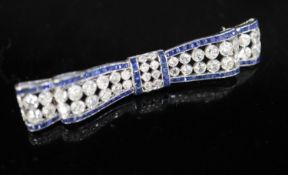 An Art Deco sapphire and diamond bow brooch mounted in white metal, 56mm, gross 8.2