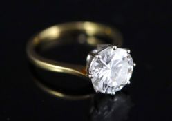 A modern 18ct gold and solitaire brilliant cut diamond ring, size O, gross 3.9 grams, the stone