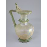 A good Roman olive green glass ewer or pitcher, Eastern Mediterranean, 3rd/4th century AD, the ovoid