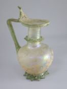 A good Roman olive green glass ewer or pitcher, Eastern Mediterranean, 3rd/4th century AD, the ovoid