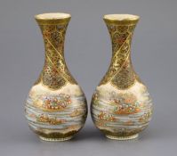 A pair of Japanese Satsuma pottery bottle vases, by Yabu Meizan, Meiji period, each finely painted