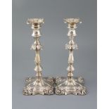 A pair of Edwardian silver candlesticks by William Hutton & Sons, with waisted knopped stems,