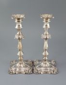 A pair of Edwardian silver candlesticks by William Hutton & Sons, with waisted knopped stems,