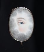 A Georgian gold mounted oval mourning brooch, with painted panel depicting an eye, the back with