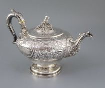 A George IV? silver pedestal teapot with thistle finial, marks rubbed, of inverted pear form and