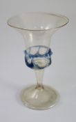 A Spanish façon de venise wine glass, 17th century, the trumpet shaped bowl enclosed by a