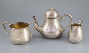 A Victorian engine turned silver three piece tea set by Richards & Brown, of baluster form, with